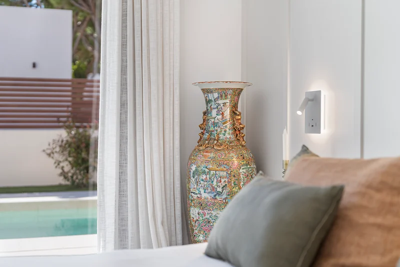 Vase by the window with a view of the pool