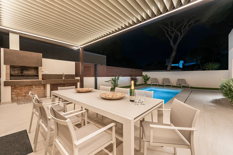 Dining area under the illuminated pergola