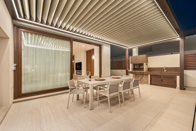 Outdoor kitchen and dining area in the evening
