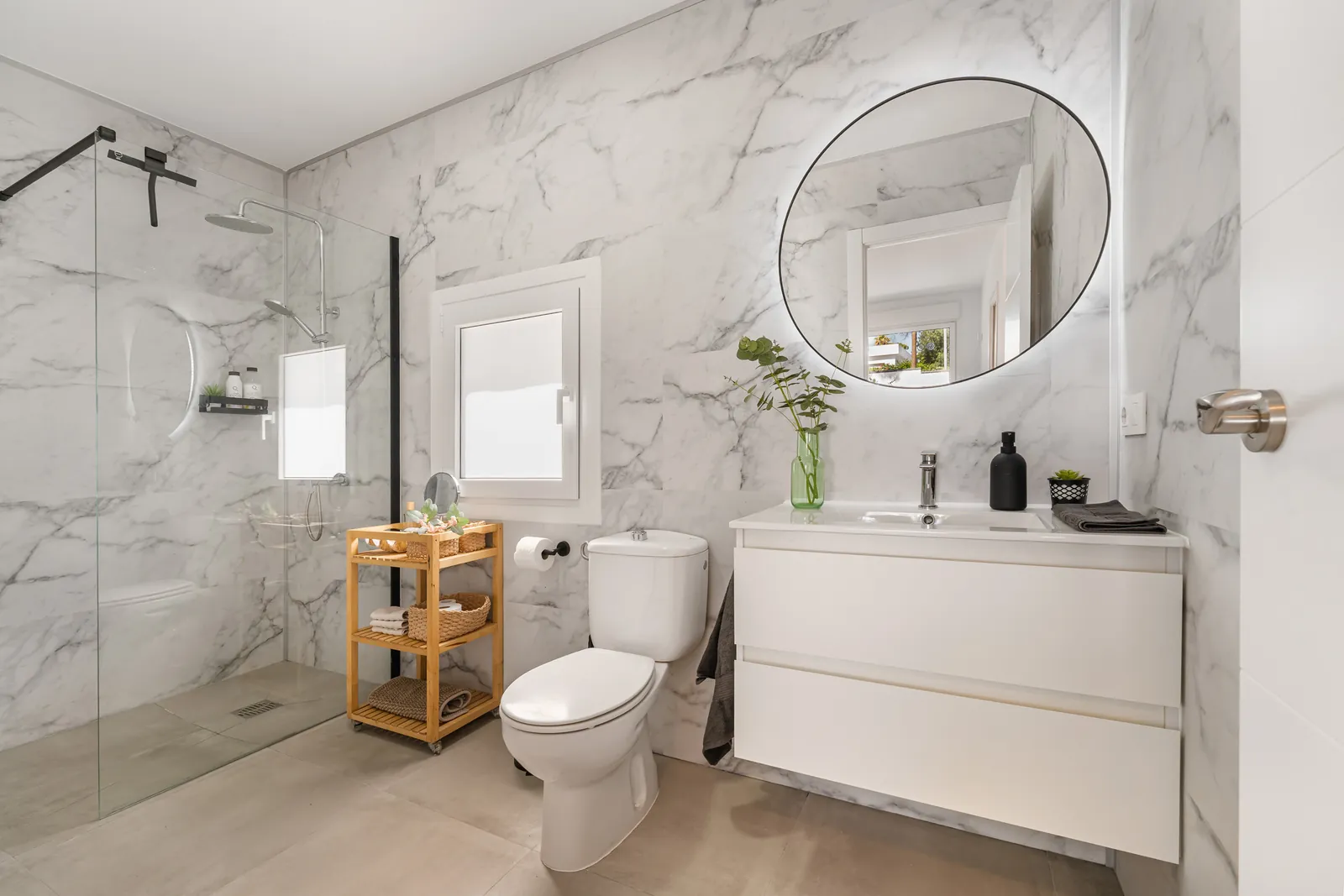 Bathroom with marble wall and round mirror